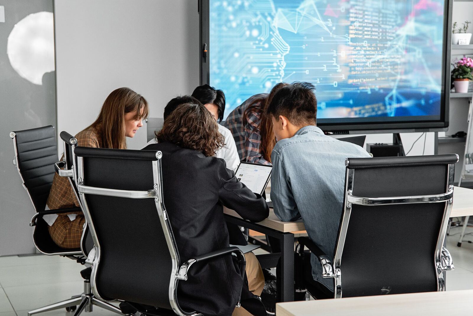 Team reviewing data on a large screen
