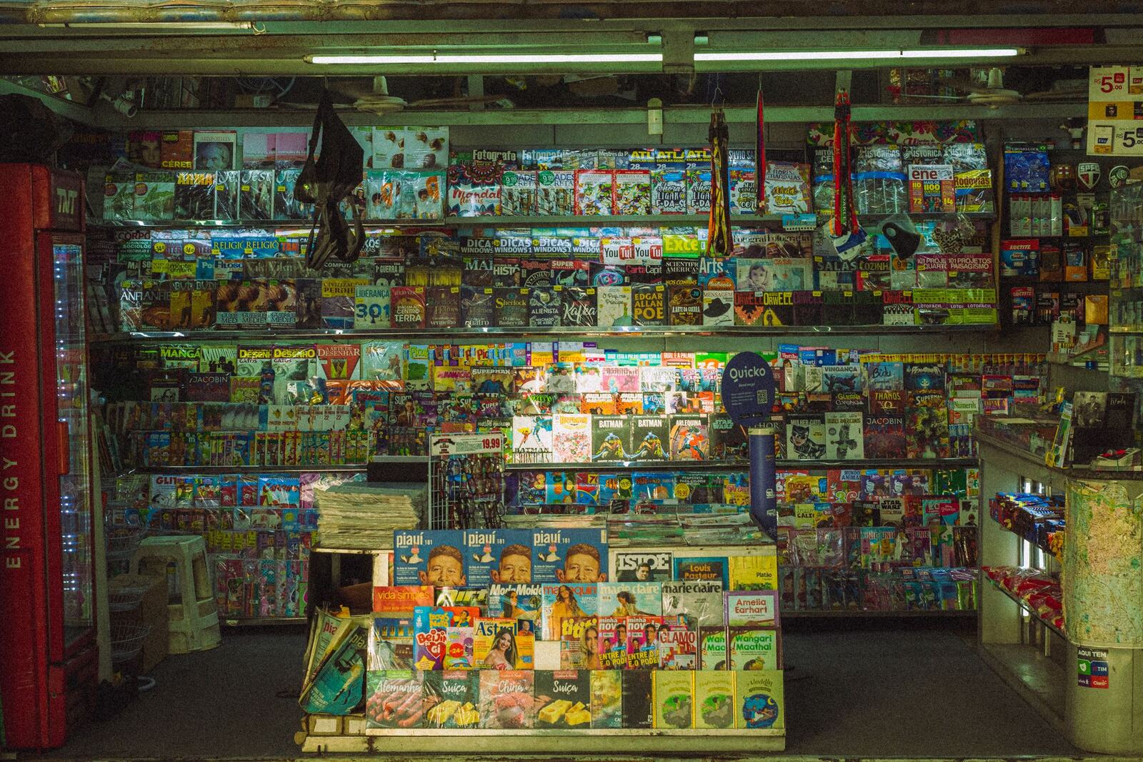 A newsstand wall filled with print magazines